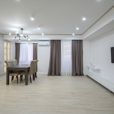 Huge white luxury kitchen in a studio apartment interior