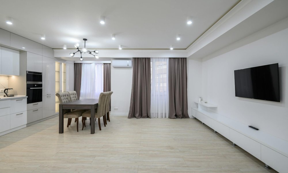 Huge white luxury kitchen in a studio apartment interior